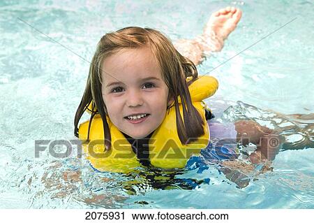 Young Girl Swimming With A Lifejacket On; Ontario Canada View Large Photo Image Stock Image - Young Girl Swimming With A Lifejacket On; Ontario Canada. Fotosearch