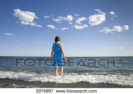 Young Girl Wading In The Waves On The Shoreline Of Lake Ontario; Ontario Canada View Large Photo Image Stock Photo - Young Girl Wading In The Waves On The Shoreline Of Lake Ontario; Ontario Canada. Fotosearch