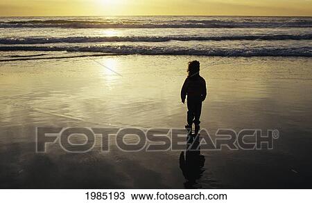 Young Girl Watching Sunset Over Ocean. View Large Photo Image Stock Image - Young Girl Watching Sunset Over Ocean.. Fotosearch