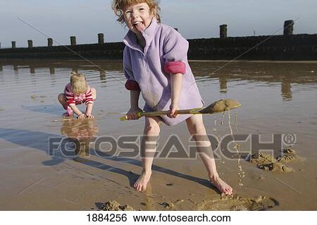 Young Girls Playing On The Beach With Spades View Large Photo Image Stock Photograph - Young Girls Playing On The Beach With Spades. Fotosearch