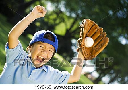 Stock Image - Young Japanese Child Playing With Baseball.. Fotosearch
