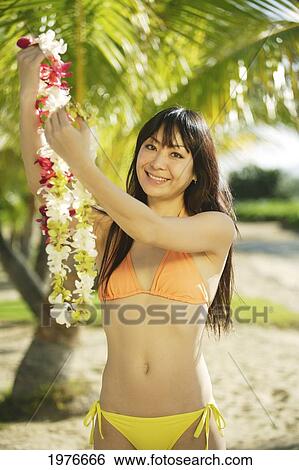 Young Japanese Girl Holding Lei. View Large Photo Image Stock Photograph - Young Japanese Girl Holding Lei.. Fotosearch