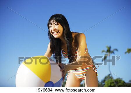 Young Japanese Girl Playing With Beach Ball. View Large Photo Image Picture - Young Japanese Girl Playing With Beach Ball.. Fotosearch