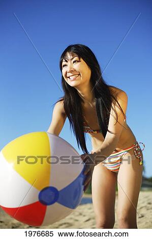 Young Japanese Girl Playing With Beach Ball. View Large Photo Image Stock Photography - Young Japanese Girl Playing With Beach Ball.. Fotosearch