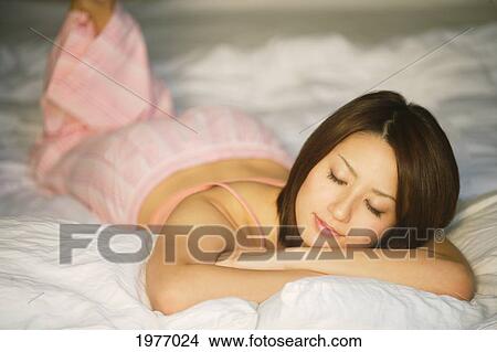 Young Japanese Girl Sleeping In Her Bedroom. View Large Photo Image Picture - Young Japanese Girl Sleeping In Her Bedroom.. Fotosearch