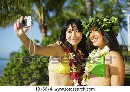 Picture - Young Japanese Girl Snapping Photograph With Hula Teacher.. Fotosearch