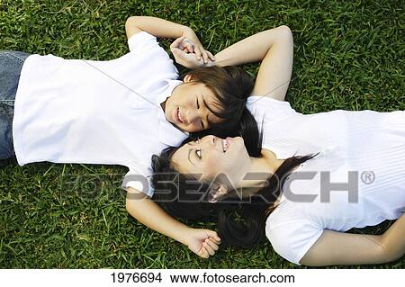 Picture - Young Japanese Mother And Child Posing In The Grass.. Fotosearch