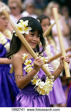 Young Keiki Girl Playing With Bamboo Sticks With Plumeria Lei Warm Smile. View Large Photo Image Stock Image - Young Keiki Girl Playing With Bamboo Sticks With Plumeria Lei Warm Smile.. Fotosearch