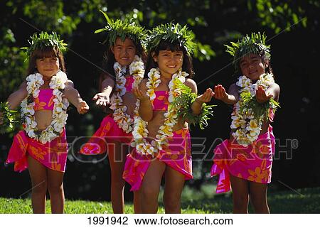 Stock Image - Young Keiki Hula Halau Dancing In Colorful Pareos With Haku And Leis. Fotosearch