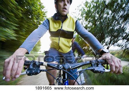 Stock Photography - Young Male Cyclists On Track. Fotosearch