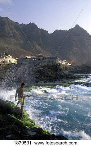 Stock Image - Young Man Fishing At Ponta Do Sol. Fotosearch