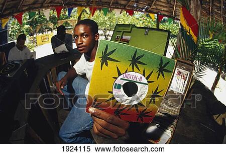 Stock Photography - Young Man Holding Record Up. Fotosearch