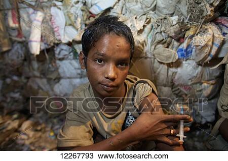 Stock Image - Young man injects drugs; Dhaka, Bangladesh. Fotosearch