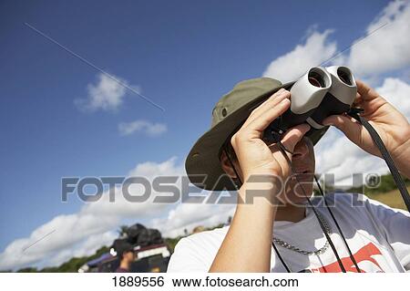 Young Man Looking Through Binoculars View Large Photo Image Stock Photograph - Young Man Looking Through Binoculars. Fotosearch