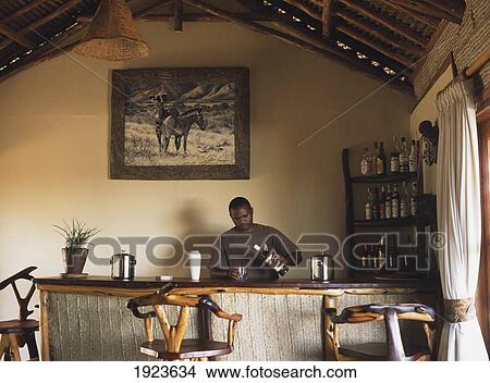 Picture - Young Man Preparing Drink In Bar. Fotosearch