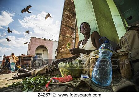 Young man sitting chewing Qat in the old City of Harar in Eastern Ethiopia; Harar, Ethiopia View Large Photo Image Stock Image - Young man sitting chewing Qat in the old City of Harar in Eastern Ethiopia; Harar, Ethiopia. Fotosearch