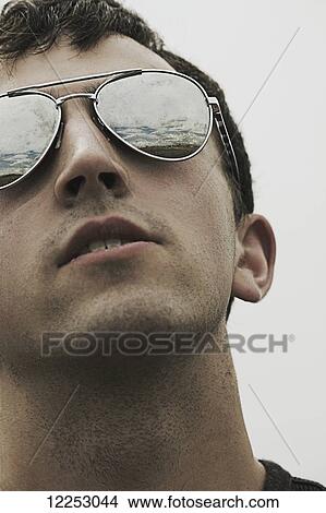 Young man wearing sunglasses; Edmonton, Alberta, Canada View Large Photo Image Picture - Young man wearing sunglasses; Edmonton, Alberta, Canada. Fotosearch
