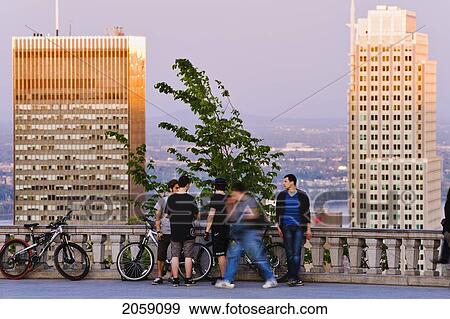 Stock Photo - Young Men Hanging Around The Lookout And Buildings At Sunset, Montreal, Quebec. Fotosearch