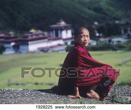 Stock Photography - Young Monk Above Mian Monastery Sitting Amongst The Mountain Landscape. Fotosearch