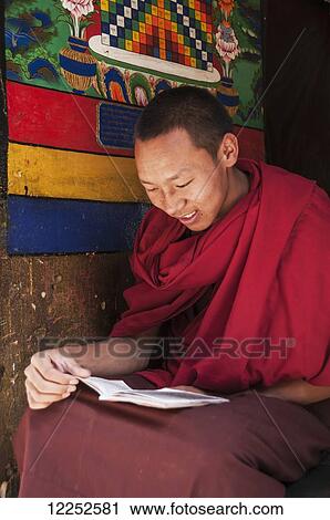 Stock Image - Young monk studying in Panchen Lama. Fotosearch