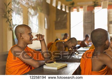 Picture - Young monks attending their class in a small temple near to Sihanoukville city; Sihanoukville, Cambodia. Fotosearch