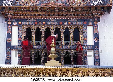 Stock Image - Young Monks Cleaning Windows. Fotosearch