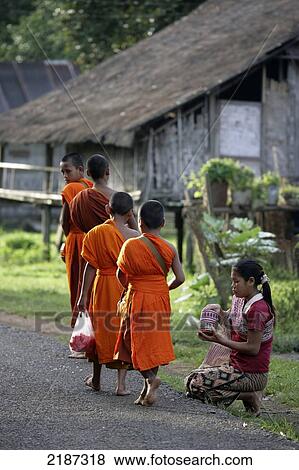 Young monks collecting alms in Tat Lo village; Champasak Province, Laos View Large Photo Image Stock Photo - Young monks collecting alms in Tat Lo village; Champasak Province, Laos. Fotosearch