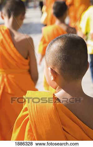 Stock Photo - Young Monks In Orange Robes, Rear View. Fotosearch