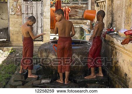 Young monks taking a shower in Wat Slaketh; Battambang, Cambodia View Large Photo Image Stock Photo - Young monks taking a shower in Wat Slaketh; Battambang, Cambodia. Fotosearch
