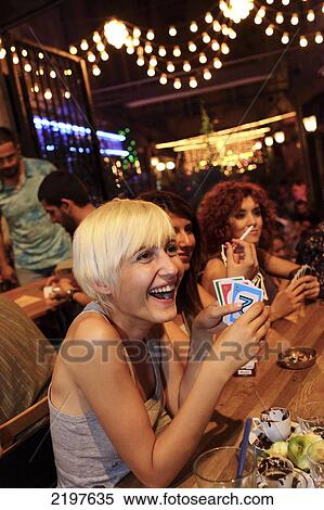 Young people playing the card game UNO in the district of Tunnel on a Saturday night. Istanbul, Turkey. View Large Photo Image Stock Photography - Young people playing the card game UNO in the district of Tunnel on a Saturday night. Istanbul, Turkey.. Fotosearch