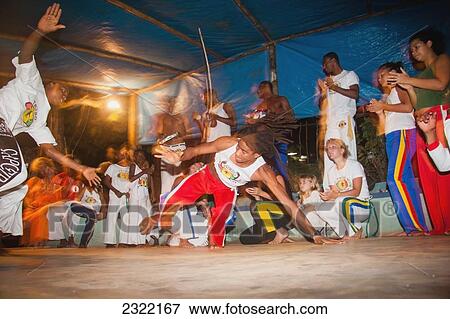 Stock Photo - Young people practicing Brazilian dance and martial arts form of Capoeira; Itacare, Bahia, Brazil. Fotosearch