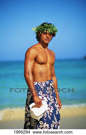 Picture - Young Polynesian Man In Lava Lava On Beach, Holds Conch Shell In Hand, Blue Sky. Fotosearch