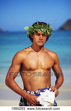 Stock Image - Young Polynesian Man With Haku On Beach, Holding Conch Shell In Hands. Fotosearch