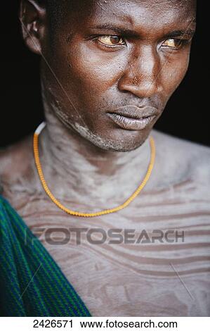 Young Suri (Surma) man in a village, Omo region, Southwest Ethiopia; Kibish, Ethiopia View Large Photo Image Stock Image - Young Suri (Surma) man in a village, Omo region, Southwest Ethiopia; Kibish, Ethiopia. Fotosearch