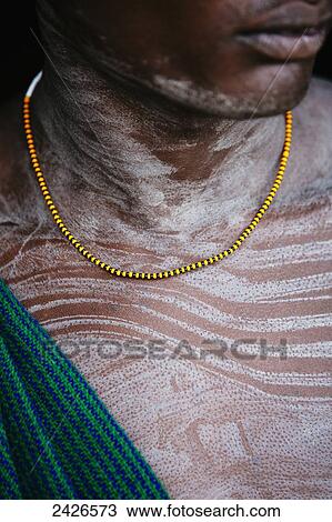 Stock Image - Young Suri (Surma) man in a village, Omo region, Southwest Ethiopia; Kibish, Ethiopia. Fotosearch