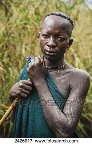 Stock Photo - Young Suri (Surma) man in village of Kibish, Omo region, Southwest Ethiopia; Kibish, Ethiopia. Fotosearch