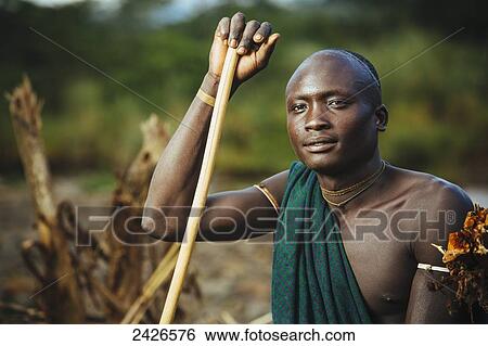 Stock Photograph - Young Suri (Surma) man in village of Kibish, Omo region, Southwest Ethiopia; Kibish, Ethiopia. Fotosearch