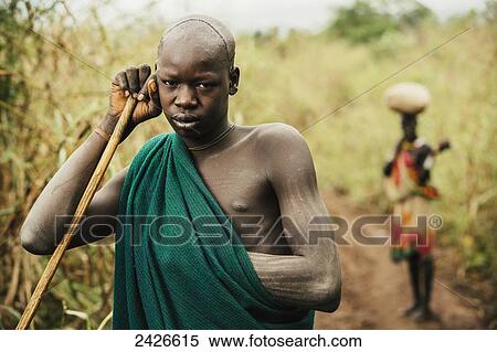 Young Suri (Surma) man in village of Kibish, Omo region, Southwest Ethiopia; Kibish, Ethiopia View Large Photo Image Stock Photography - Young Suri (Surma) man in village of Kibish, Omo region, Southwest Ethiopia; Kibish, Ethiopia. Fotosearch