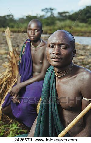 Stock Photo - Young Suri (Surma) men in village of Kibish, Omo region, Southwest Ethiopia; Kibish, Ethiopia. Fotosearch