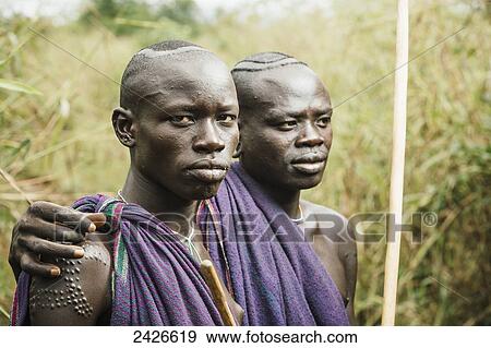 Stock Photo - Young Suri (Surma) men in village of Kibish, Omo region, Southwest Ethiopia; Kibish, Ethiopia. Fotosearch