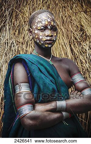 Stock Image - Young Surma (Suri) woman with traditional face decoration, Southwest Ethiopia; Kibish, Ethiopia. Fotosearch