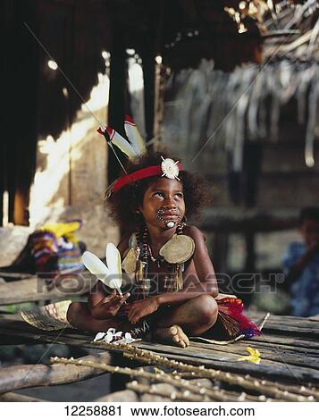 Stock Image - Young Trobriand Island girl in traditional dress; Trobriand Islands, Papua New Guinea. Fotosearch