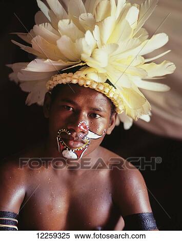 Stock Photography - Young Trobriand Island man in traditional dress; Trobriand Islands, Papua New Guinea. Fotosearch
