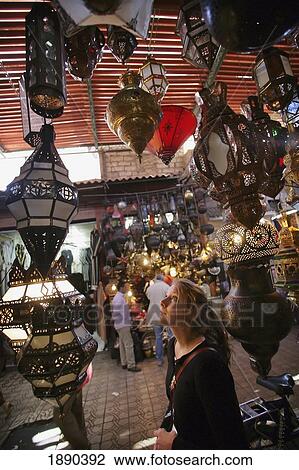 Young Woman Browsing For Moroccan Lanterns In A Market Stall In The Souk. View Large Photo Image Stock Image - Young Woman Browsing For Moroccan Lanterns In A Market Stall In The Souk.. Fotosearch