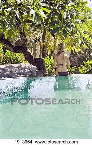 Young Woman By Hotel Swimming Pool View Large Photo Image Picture - Young Woman By Hotel Swimming Pool. Fotosearch