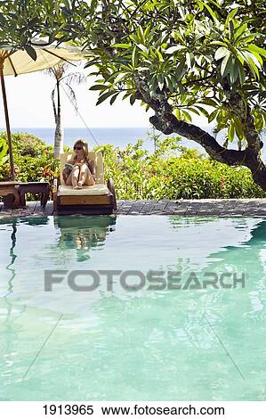Young Woman By Hotel Swimming Pool View Large Photo Image Stock Photography - Young Woman By Hotel Swimming Pool. Fotosearch