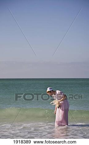 Young Woman Collecting Shells On Lido Beach View Large Photo Image Stock Photo - Young Woman Collecting Shells On Lido Beach. Fotosearch