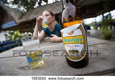 Young Woman Drinking Beer Lao In Si Phan Don Area, Mekong River, Southern Laos View Large Photo Image Stock Photography - Young Woman Drinking Beer Lao In Si Phan Don Area, Mekong River, Southern Laos. Fotosearch