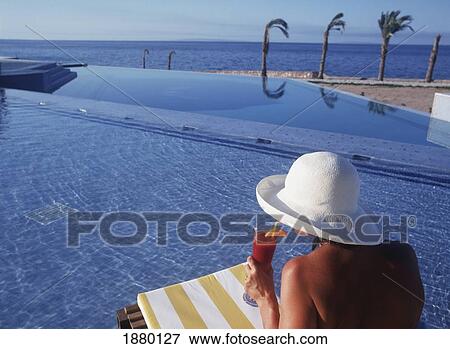 Young Woman Drinking Cocktail At Swimming Pool Deck At Oberoi Sahl Hasheesh Resort View Large Photo Image Stock Photo - Young Woman Drinking Cocktail At Swimming Pool Deck At Oberoi Sahl Hasheesh Resort. Fotosearch