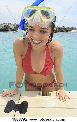 Stock Image - Young Woman Getting Out Of The Sea In Snorkeling Gear.. Fotosearch